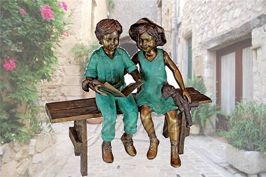 Life size outdoor sitting bronze children reading sculpture